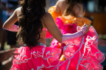 Sunny close-up of the colorful ruffled dresses of Carnival costumes dancing in bright sunlight in Rio de Janeiro, Brazil