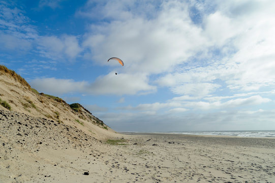 Denmark, Jutland, Thy National Park, paraglider on the beach