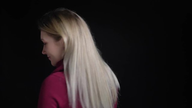 Closeup shoot of young pretty caucasian female looking at camera and smiling seductively posing in front of the camera