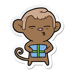 sticker of a cartoon suspicious monkey with present