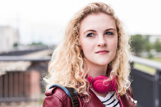 Portrait Of Young Blond Woman With Pink Headphones