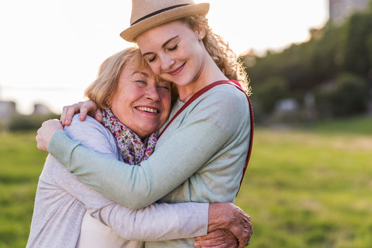 Happy grandmother and granddaughter hugging each other