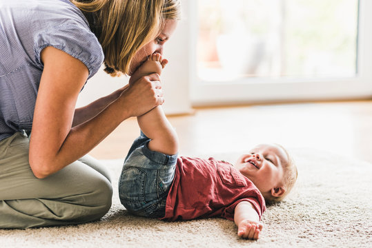 Mother playing with son at home