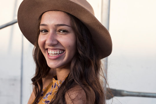 Portrait of happy young woman wearing a hat