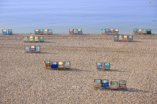 Colorful canvas chairs at the shingle beach, Beer, Jurassic Coast, Devon, England, United Kingdom, Europe