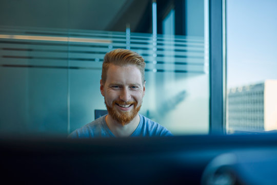 Happy businessman at desk in office
