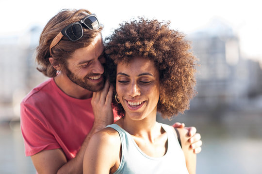 Happy Young Couple, Man Whispering Into Woman's Ear