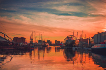Fototapeta na wymiar Panoramic view of old port and Biosphere (Glass sphere) in Genoa at sunset, Liguria, Italy
