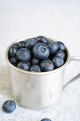 Blueberries in a rustic metal cup still life, selective focus