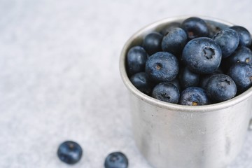 Blueberries in a rustic metal cup still life, selective focus