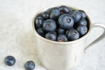 Blueberries in a rustic metal cup still life, selective focus