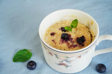 Homemade blueberry mug cake muffin, selective focus