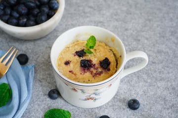Homemade blueberry mug cake muffin, selective focus