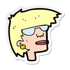 sticker of a cartoon female face with glasses