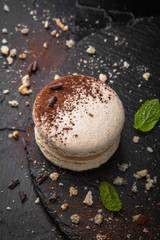 French Colorful Macarons on Black Background Vertical Close Up