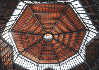 A wide-angle view from inside of a contemporary dome of Born Market (Mercat del Born) in la Ribera district of Barcelona, Spain, made of iron beams and wood