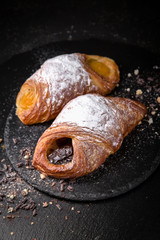 Sweet Soft Buns. Puff envelope with fruit and powdered sugar. Bakery
