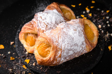 Sweet Soft Buns. Puff envelope with fruit and powdered sugar. Bakery