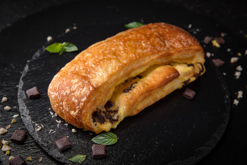 Sweet Soft Buns. Puff pastry bun with custard, raisins and chocolate. Bakery