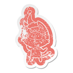 happy cartoon distressed sticker of a cat wearing santa hat
