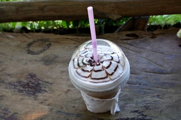 Top view of chocolate frappe coffee with whipped cream on wooden table, frappuccino