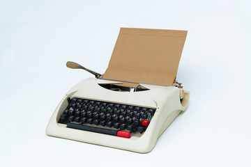 Retro typewriter with blank paper sheet on white.