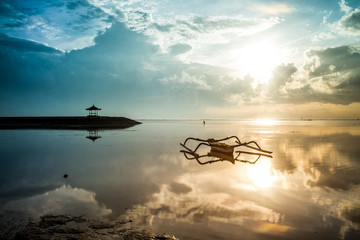 Fototapeta na wymiar fisherman boat at sunrise in Sanur beach Bali Indonesia 1 