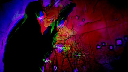 Fototapeta na wymiar Man's silhouette playing guitar with psychedelic colors swirling about.