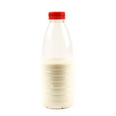 Half a bottle of milk. Close up. Isolated on white background