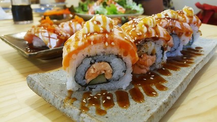 Rainbow Sushi Roll with salmon, eel, tuna, avocado, royal prawn, cream cheese Philadelphia, caviar tobica, chuka. Sushi menu. Japanese food
