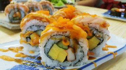 Rainbow Sushi Roll with salmon, eel, tuna, avocado, royal prawn, cream cheese Philadelphia, caviar tobica, chuka. Sushi menu. Japanese food