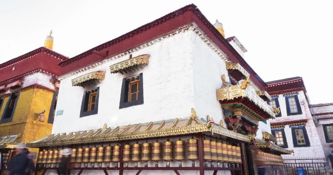 Prayer wheels in Jokhang temple. The characters (in Newari language & Tibetan) on the wheels are the mantras "Om Mani Padme Hum", each word means "sacred, bead, lotus flower, spirit of enlightenment"