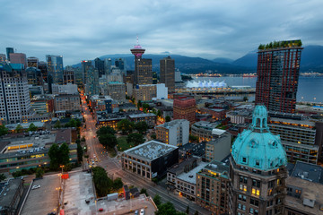 Downtown Vancouver, British Columbia, Canada - June 22, 2018: Aerial view of the modern city during night time after a cloudy sunset.