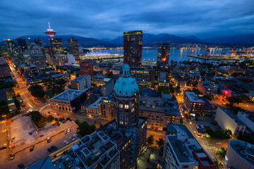Downtown Vancouver, British Columbia, Canada - June 22, 2018: Aerial view of the modern city during night time after a cloudy sunset.
