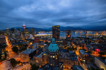 Downtown Vancouver, British Columbia, Canada - June 22, 2018: Aerial view of the modern city during night time after a cloudy sunset.