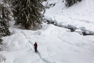 Snowshoeing in the snow during a white winter day. Taken on a hike to Alexander Falls, near Whistler and Squamish, North of Vancouver, BC, Canada.