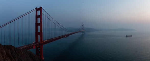 Beautiful panoramic view of Golden Gate Bridge during a hazy sunset. Taken in San Francisco, California, United States.