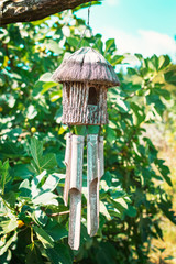 Wooden bird house hanging on a branch of tree - Image
