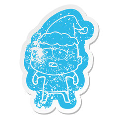 cartoon distressed sticker of a tired bald man wearing santa hat