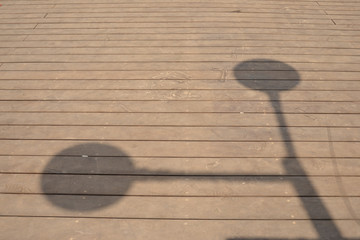 The shadow of the street-lamp on the wooden flooring. For design, banner and layout