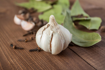 Spices and garlic on a wooden table.