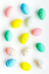 Colorful Easter eggs background on white top view