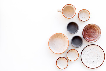 Ceramic tableware pattern. Empty plates and mugs on white background top view copy space