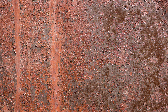 Old metal wall covered with cracked terracotta paint. For design, banner and layout