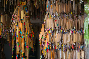 Empty wooden prayer tablets hanging inside temple