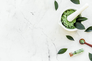 Make cosmetics with tea tree essential oil. Homemade cosmetics. Fresh tea tree leaves, mortar and...