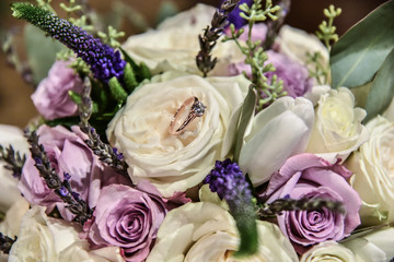 bouquet of roses and wedding ring