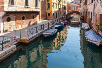 Fototapeta na wymiar View of the narrow side of the canal, moored boats, Venice, Italy