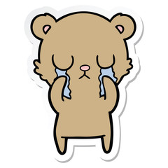 sticker of a crying cartoon bear