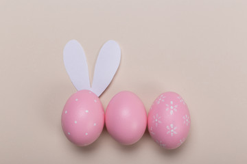 Pink easter eggs in nest on pastel color background with space. Concept